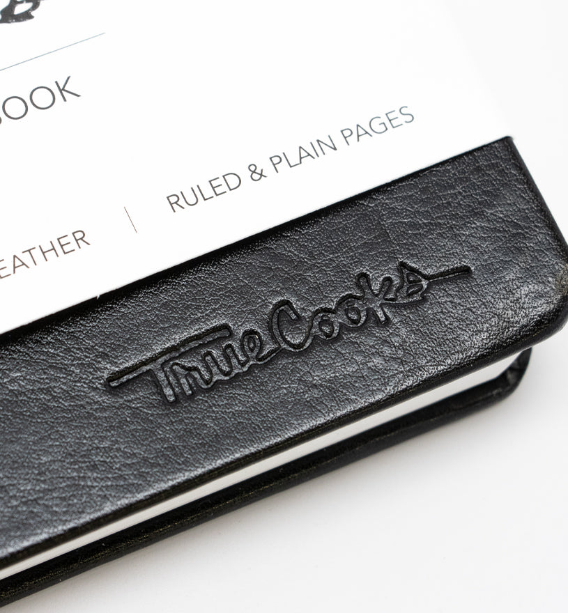 TrueCooks Stone Paper Notebook detail photo of TrueCooks logo
