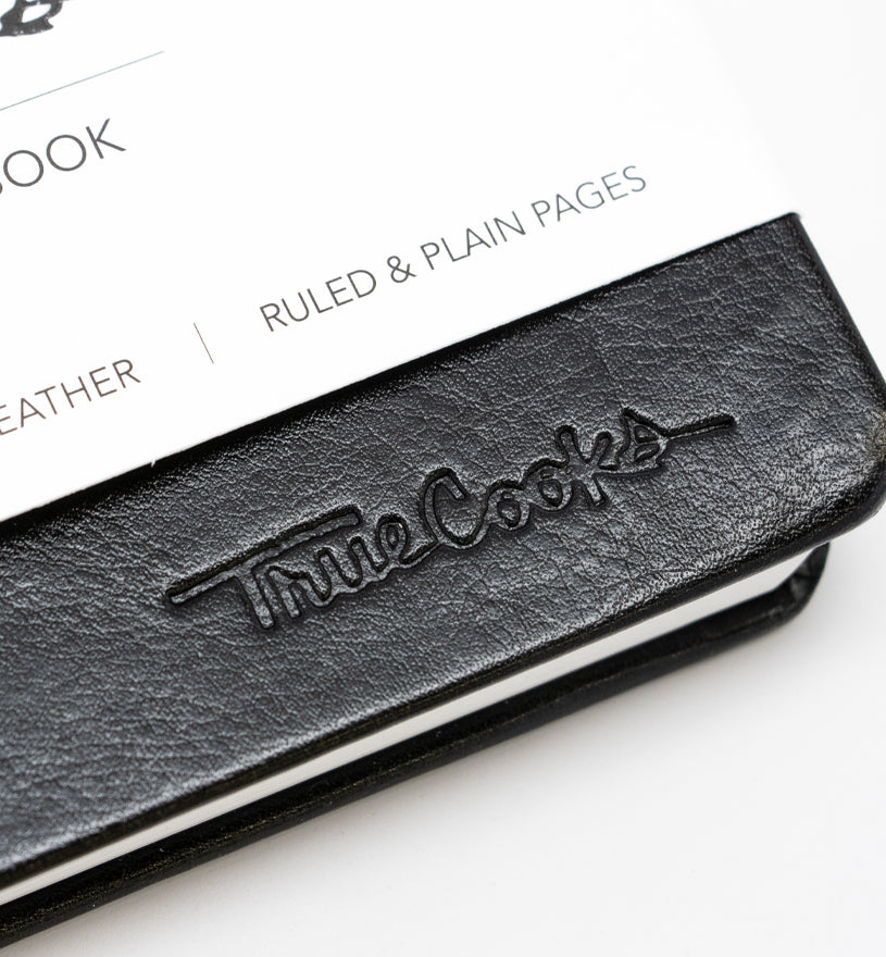 TrueCooks Stone Paper Notebook detail photo of TrueCooks logo 
